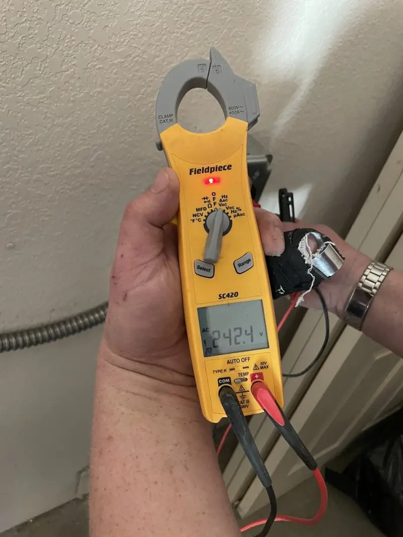 Voltage testing with clamp meter during Whole House Surge Protector in Urbandale